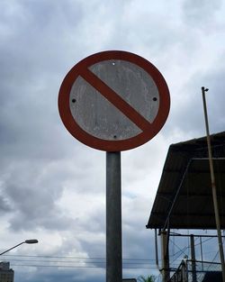 Low angle view of road sign against sky