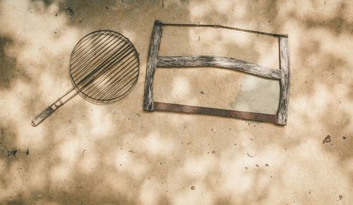 High angle view of old metal on table against wall