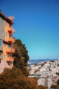 View of townscape against clear blue sky