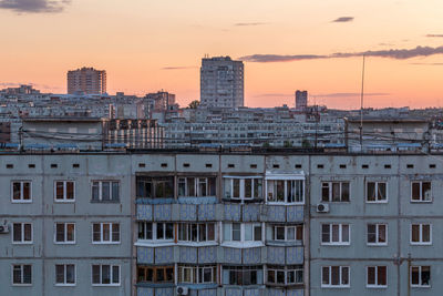 Buildings in city at sunset