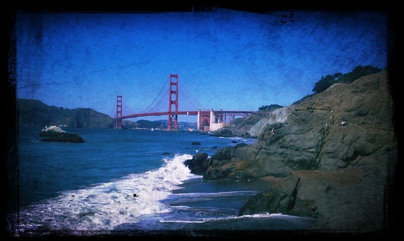 water, connection, bridge - man made structure, suspension bridge, built structure, architecture, transfer print, engineering, sea, bridge, transportation, river, auto post production filter, golden gate bridge, sky, international landmark, travel destinations, famous place, bay of water, rock - object