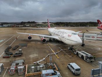 High angle view of airplane on airport runway against sky