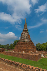 Old temple building against cloudy sky