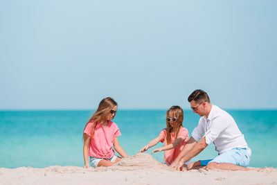 People on beach against sky