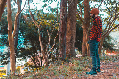 Rear view of woman standing in forest