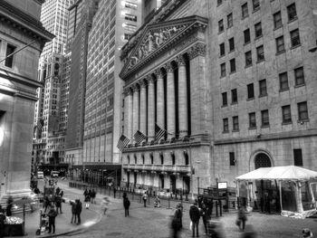 People on street by new york stock exchange at lower manhattan in city