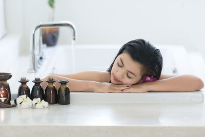 Young woman relaxing in bathtub