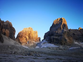 Rock formations against clear blue sky