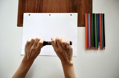 Midsection of person holding book