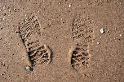 High angle view of footprints on sand