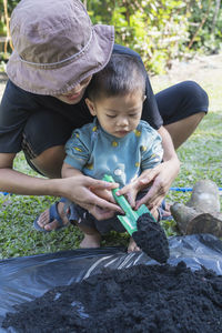 High angle view of boy watering plants