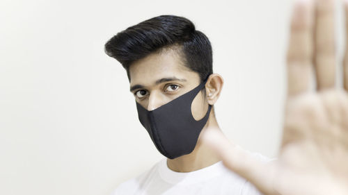 Portrait of young man against white background