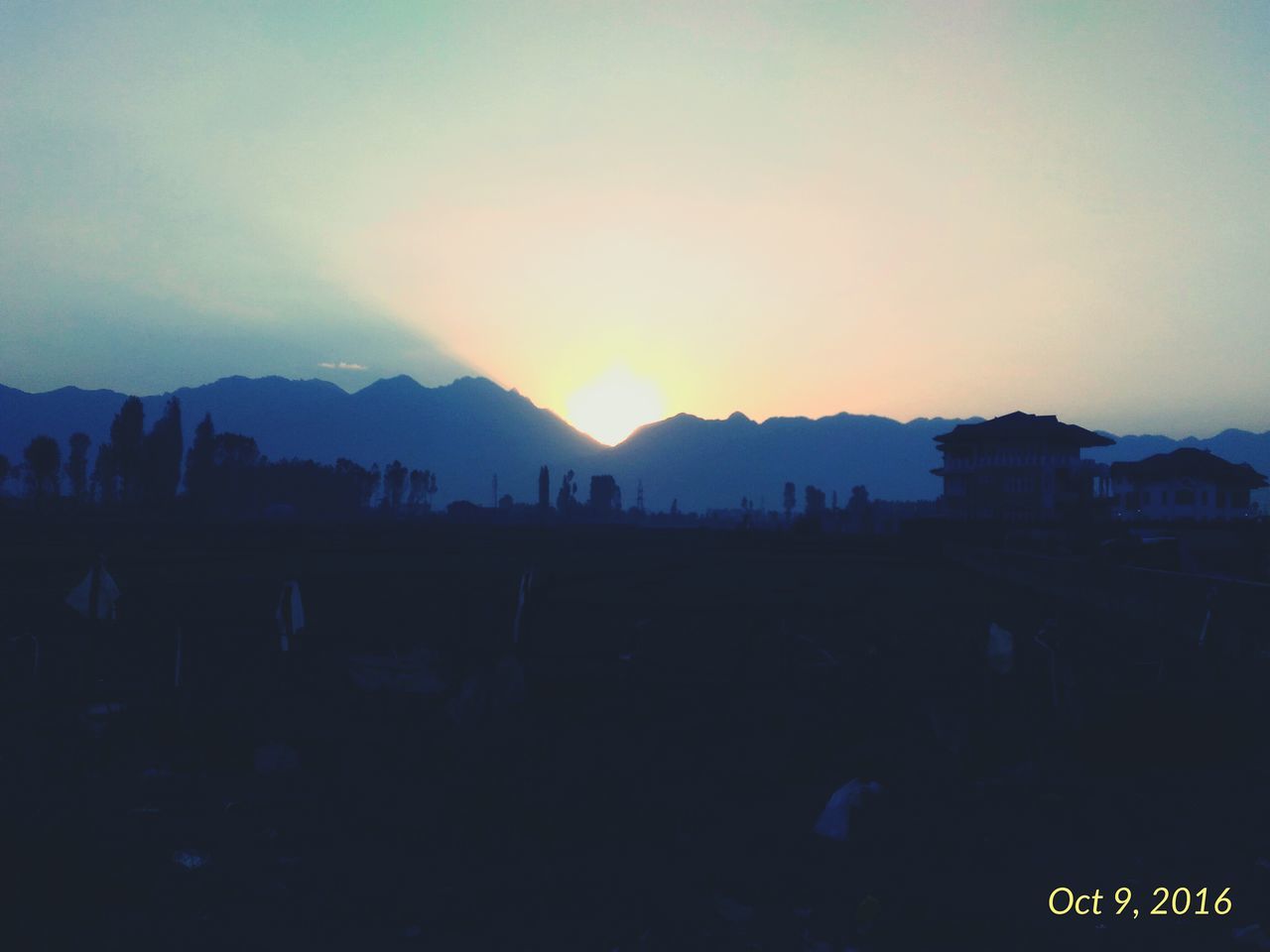 VIEW OF SILHOUETTE BUILDINGS IN FRONT OF MOUNTAINS