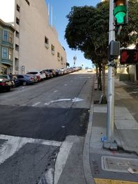 Cars on road along buildings