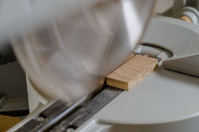 Cutting a wooden board on carpentry machine. woodworking industry.