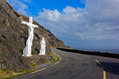 Road amidst rocks against sky