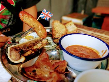 Cropped image of person having food at table