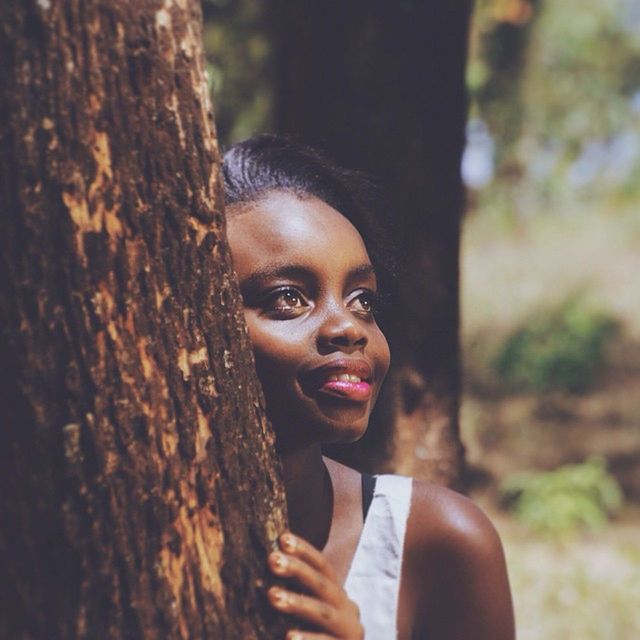 young adult, portrait, lifestyles, looking at camera, person, front view, headshot, focus on foreground, young women, leisure activity, close-up, smiling, tree, tree trunk, casual clothing, human face, day