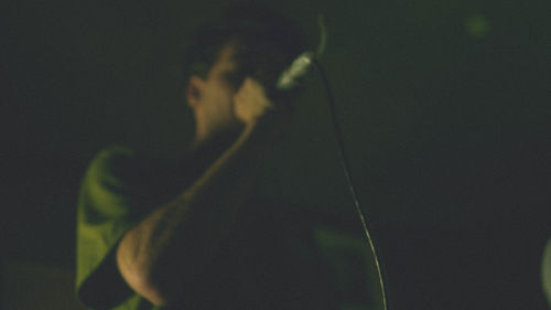 Close-up of man standing in the dark