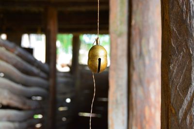 Close-up of bell hanging on stable