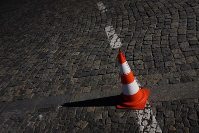 High angle view of red umbrella on cobblestone street