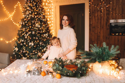 Portrait of woman holding christmas tree