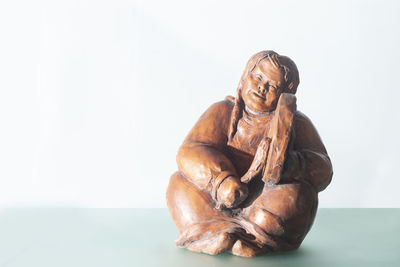 Close-up of statue against white background
