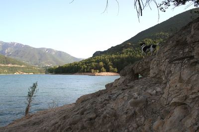 Scenic view of lake and mountains against clear sky