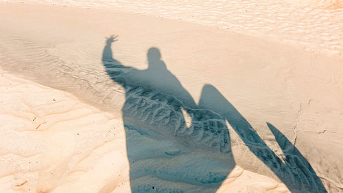 Shadow of person on sand