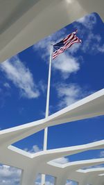 Low angle view of flag against blue sky