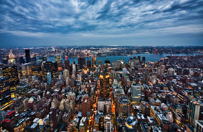 High angle view of illuminated city buildings against sky