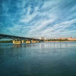 View of bridge over river against cloudy sky