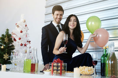 Young man and woman standing at balloons