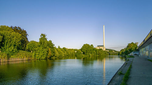 Scenic view of river against clear blue sky