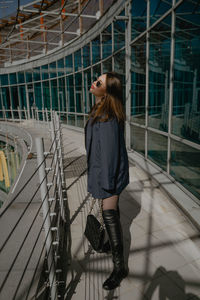 Full length of young woman standing in city