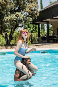 Woman sitting in swimming pool