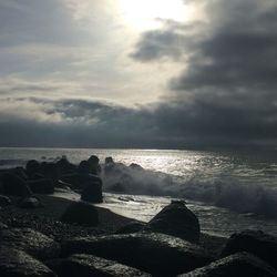 Scenic view of sea against cloudy sky