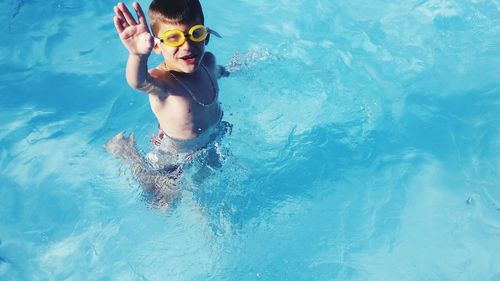 Portrait of smiling young woman swimming in pool