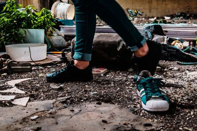 Low section of man and woman standing on mud