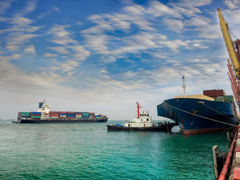 Ship moored at harbor against sky