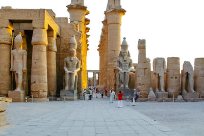 Statues at temple against sky