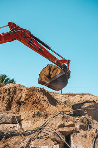 Low angle view of construction site against clear blue sky