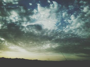 Low angle view of storm clouds over landscape