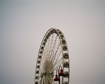 Low angle view of ferris wheel against clear sky