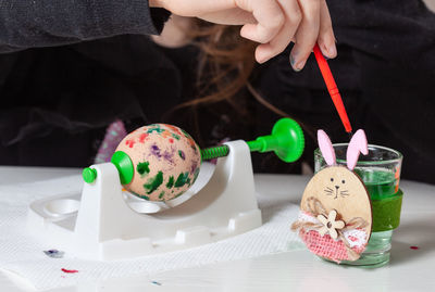 Close-up of hand holding ice cream on table