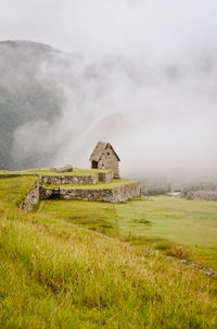 Built structure on field against sky