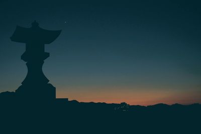 Silhouette landscape against sky at night