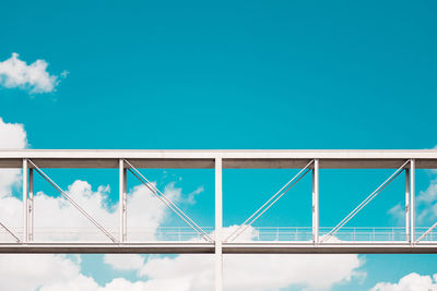 Low angle view of bridge against blue sky