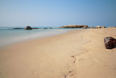 Scenic view of beach against clear sky