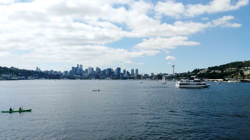 Scenic view of sea by buildings against sky